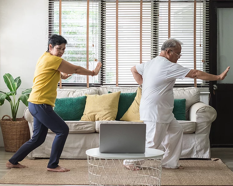 Mature couple practicing Tai Chi in their home