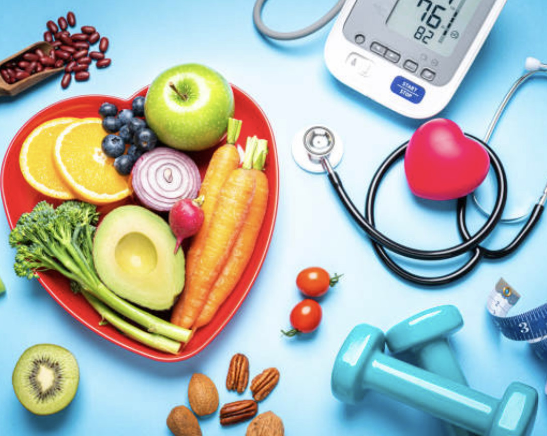 Items related to health including fruits and vegetables, weights, and a blood pressure monitor